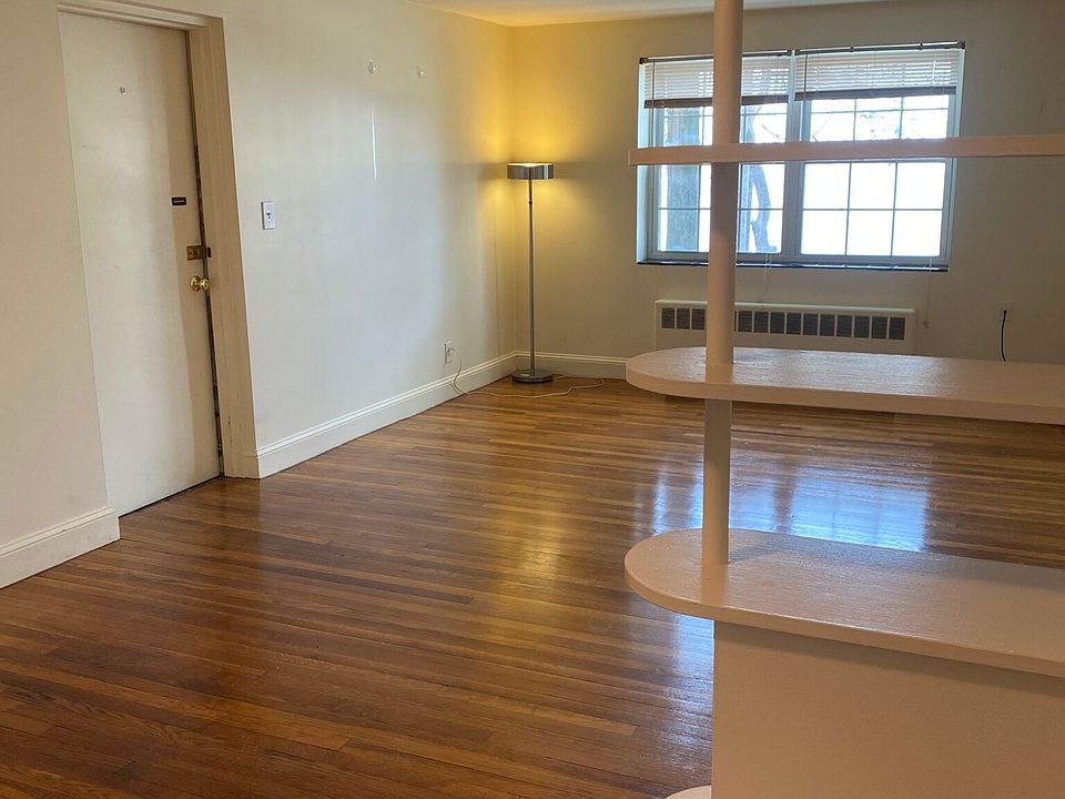 Nice-sized living room/dining area with lots of sunlight & gleaming hardwood floors