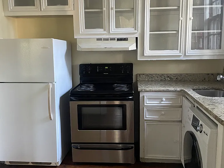 Kitchen which shows washer/dryer combo, refrigerator/freezer and stove