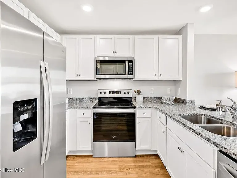 Model home to show layout. Countertops are white in Kitchen