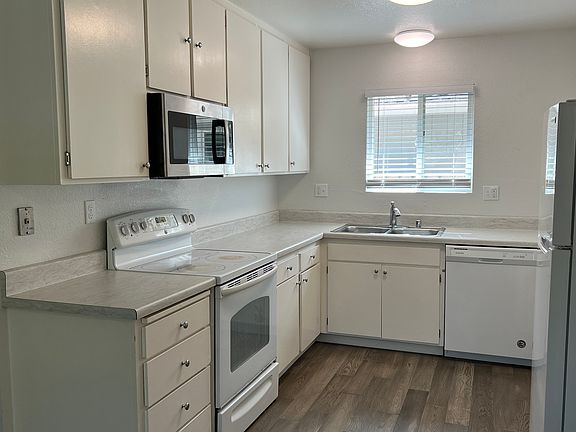 Newer dishwasher, LVP flooring, electric range, microwave, and newer refrigerator included