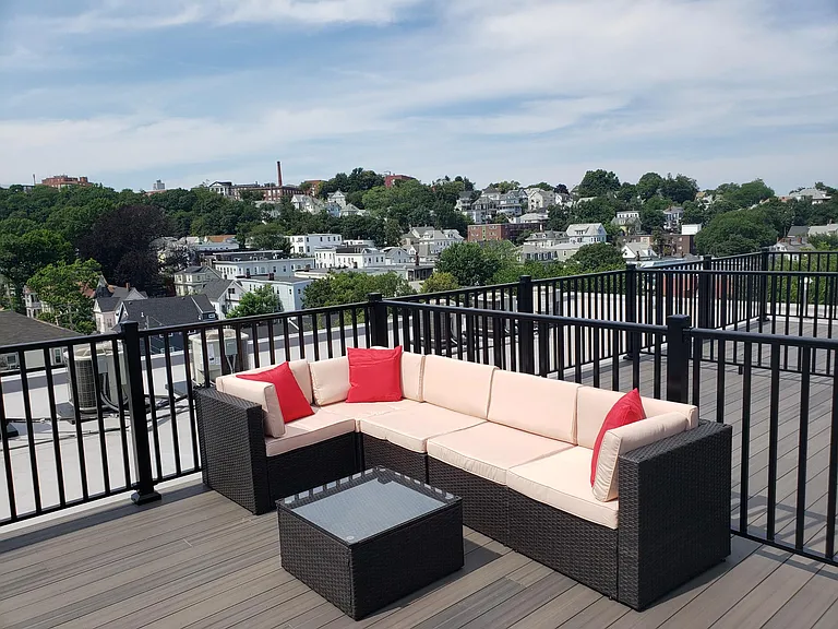 Semi private roofdeck. (The fenced-in portion shown here furnished belongs to the unit. The other fenced off portions are common space or another unit's property.)