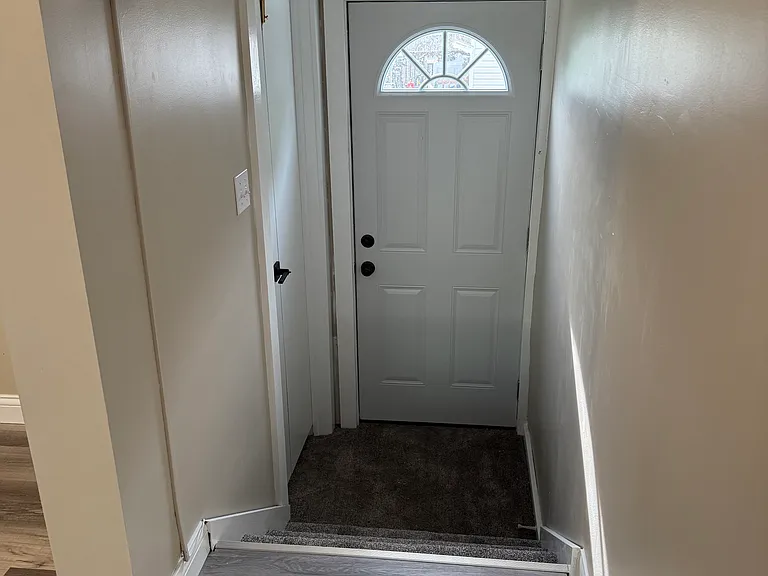 Side door and door to the basement on the left.