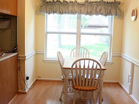 Cheery Breakfast room overlooks lush back yard.