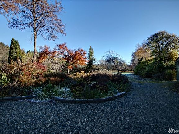Parking area with garden in back ground... This is only a small sample of the gardens that meander throughout this property. These gardens and landscaping display the owners pride of ownership.