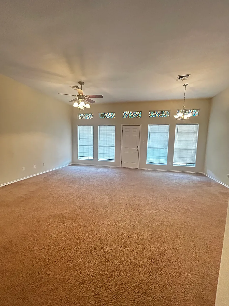 Living room. Door to backyard. - 1702 Brook Ln
