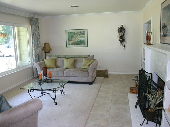 Cozy living room w/ large picture window and cozy fireplace w/ built-ins
