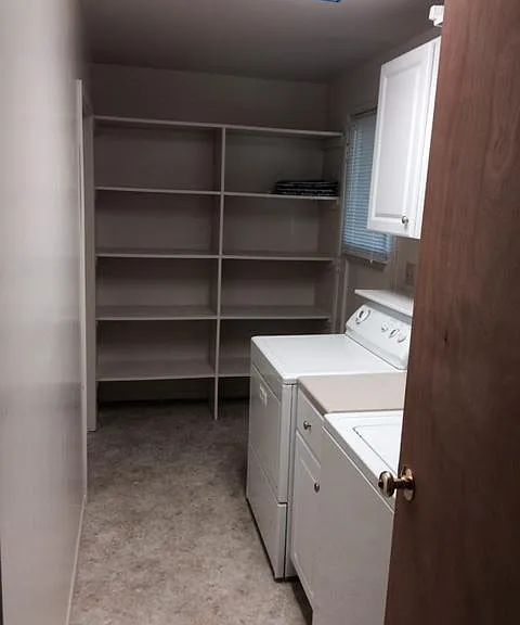 Laundry room off kitchen with pantry storage