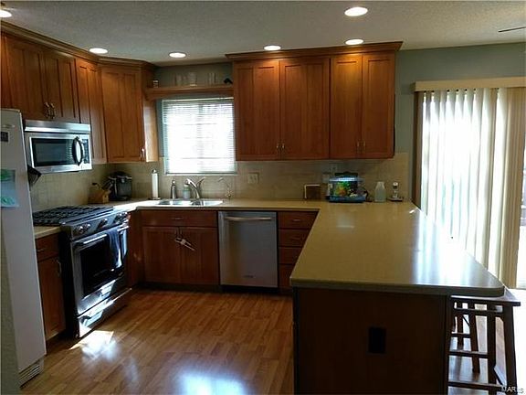 The kitchen is stunning with its new cabinets, stainless steel gas stove and matching dishwasher.