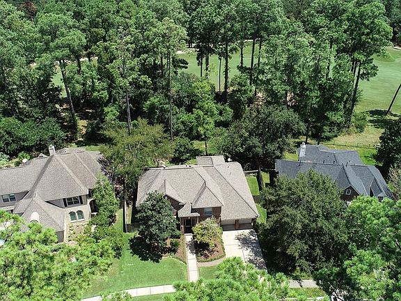 Aerial view showing the lush green space and Golf Course behind the home.