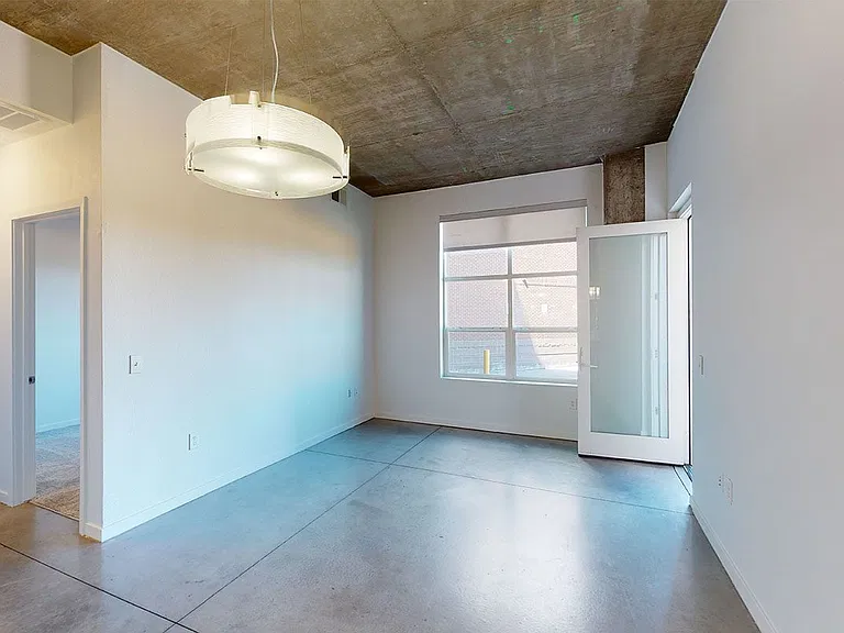 Apartment living room with concrete flooring and balcony or patio in sele