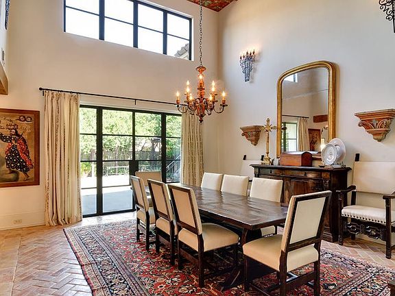 A second view of the dining room reveals more of the herringbone-pattern Saltillo tile floor.