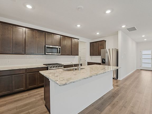 The kitchen features slate colored cabinets and granite countertops.
