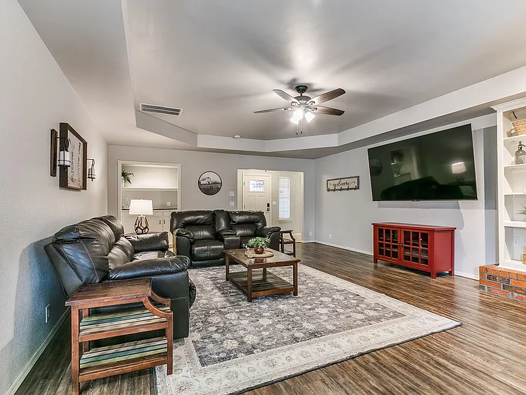 Comfortable living room with reclining sofa and huge 85 inch TV