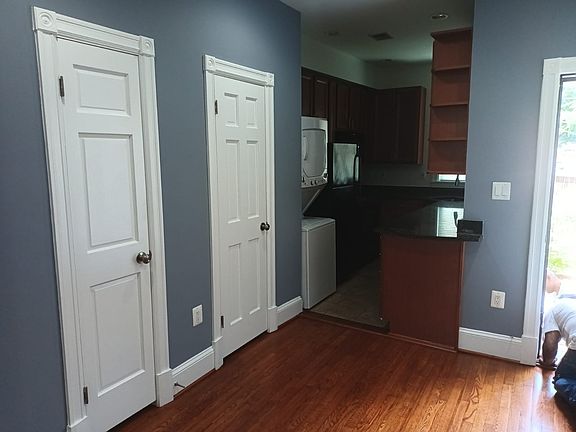 Storage closet, powder room, kitchen with washer/dryer