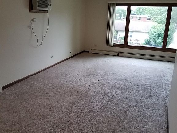 Large front room and dining room with new air conditioner.