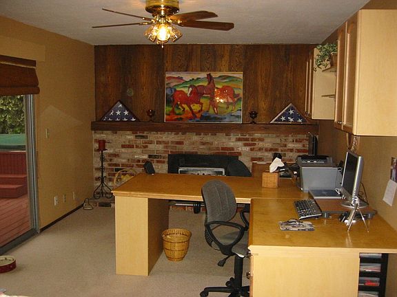 Separate family room with wood stove backed by brick