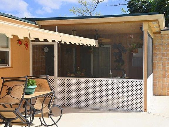 Exterior pool side w/ screen patio