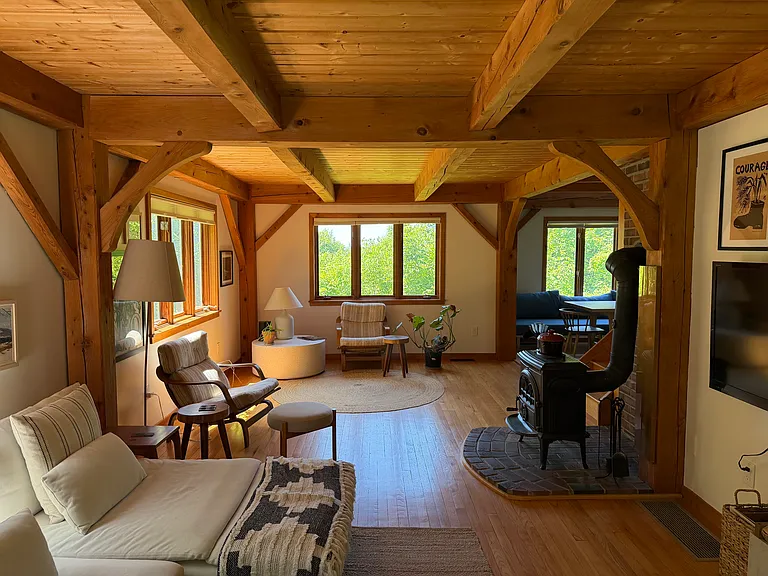 Cozy post and beam design with wood stove