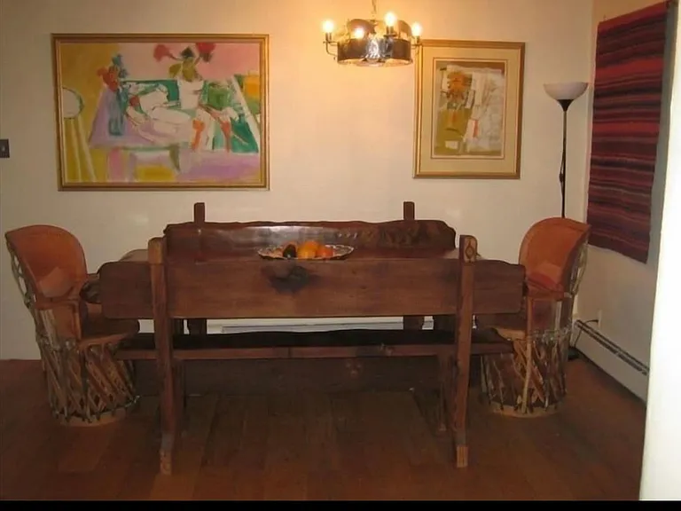 Hard carved kitchen table and benches seat 8 easily.