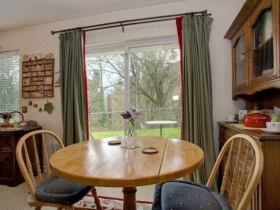Dining area opens to living space and has sliders to private patio.