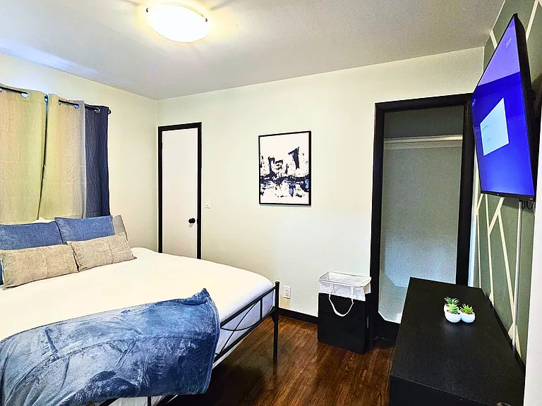 Main floor bedroom with queen bed and roku TV