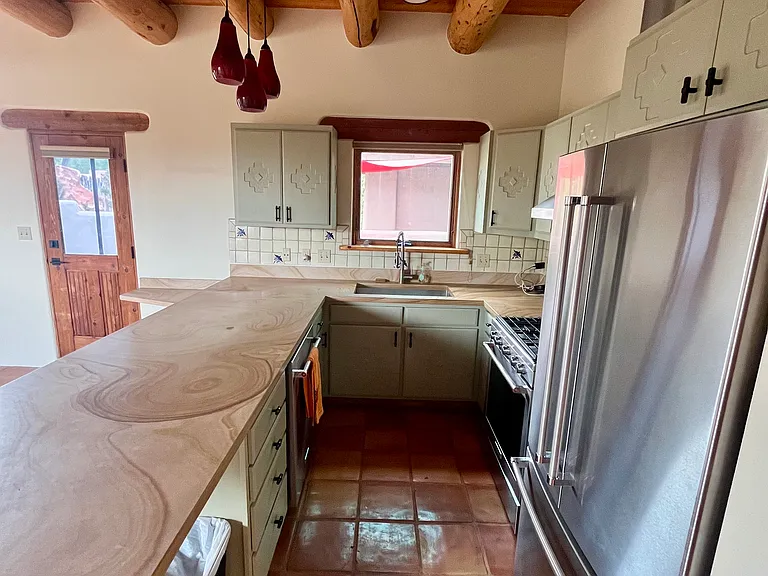 Living space opens into the modern kitchen.