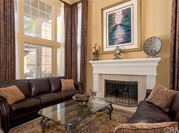 Living room with fireplace and stunning draperies.