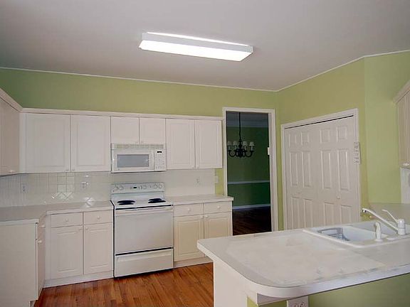 Spacious Kitchen is full of warmth and light with extra-spacious pantry!