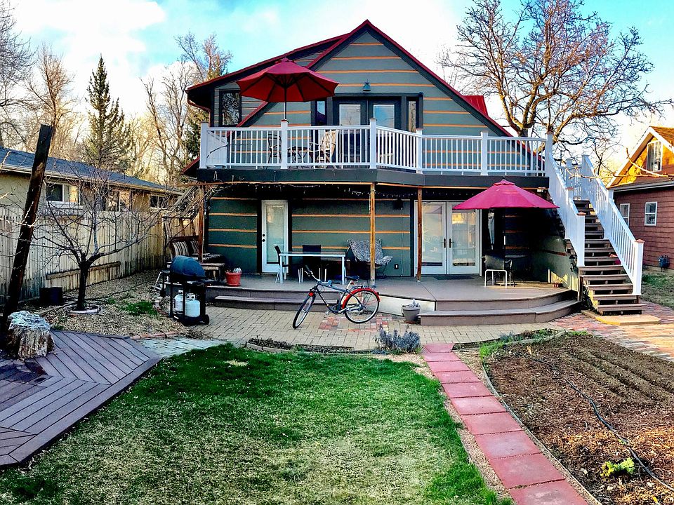 back yard has south facing decks and views that get lots of light. Upstairs bedroom/ suite, downstairs bedroom, and kitchen all have doors that access back decks.