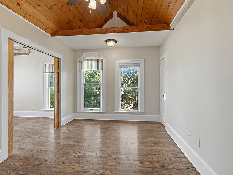 Bedroom two features vaulted ceilings, floor to ceiling windows, hardwood floors and plenty of room for everything you need to make this space your own.