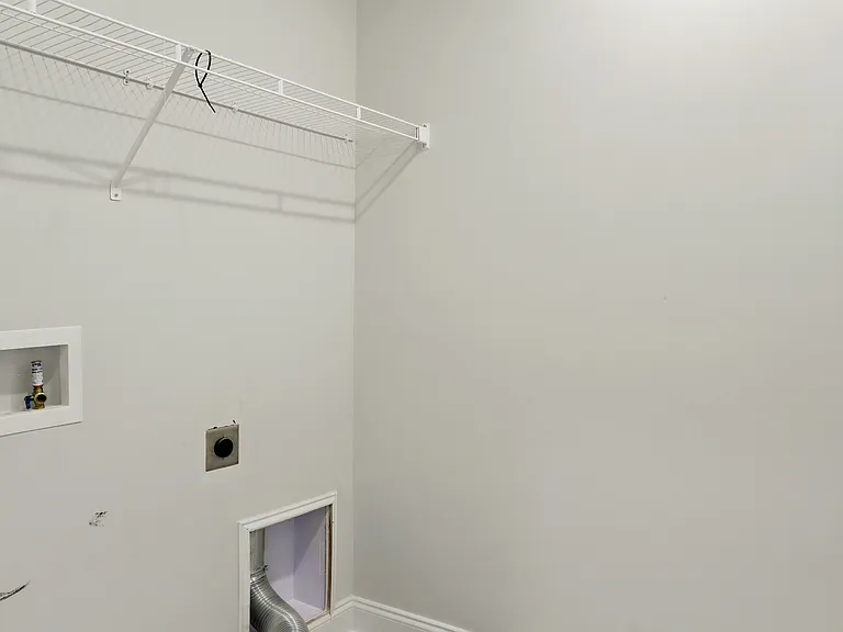 Laundry Room - Upstairs laundry room conveniently located near all three bedrooms, with extra storage cabinets and shelving. New washer and dryer units have been installed (not pictured).