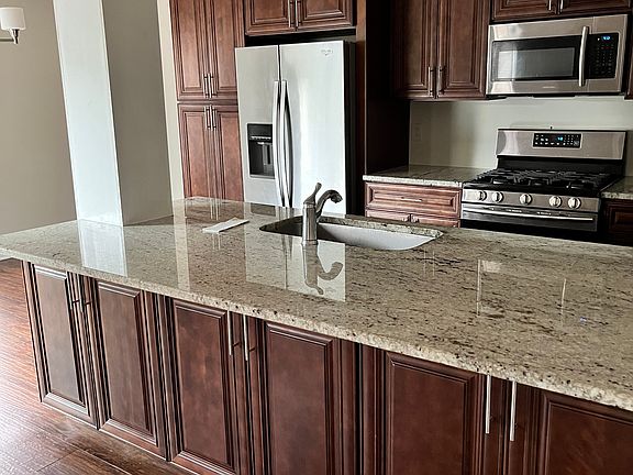 Loads of Natural light in this Gourmet Kitchen- Upgraded Granite countertops- Real wood custom cabinetry- w/ Gas 5-burner Stove & Newly installed white cushioned subway backsplash tile
- Walk in Laundry Room with Washer and Dryer off of Kitchen