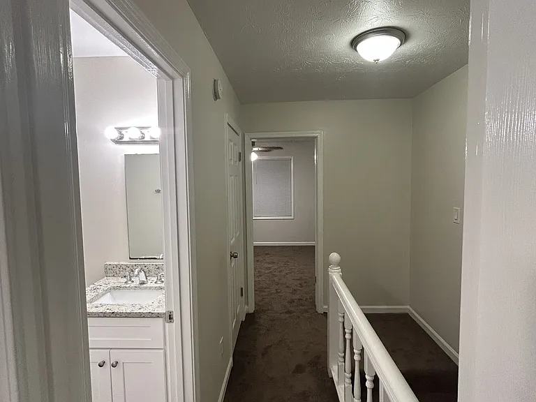 Upstairs hallway. Two separate bedrooms with bathroom in the middle.