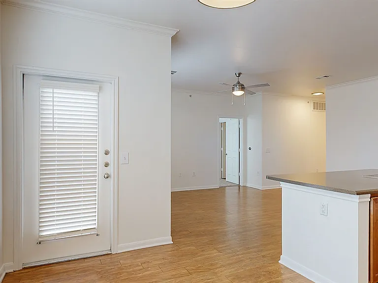 Apartment dining and living room with wood-style flooring.