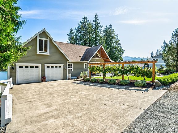 Cedar arbor with over "100 year old, old world grapes". Artificial turf makes for low maintenance yard. Level entry from garage to interior of house.
