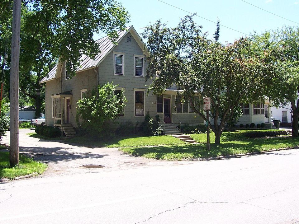 1880's farmhouse with standing seam metal roof, converted to up/down duplex. Available downstairs unit has private front entry through secure enclosed porch as well as a smaller, private covered deck rear entry. Side alley entry shown in photo is private