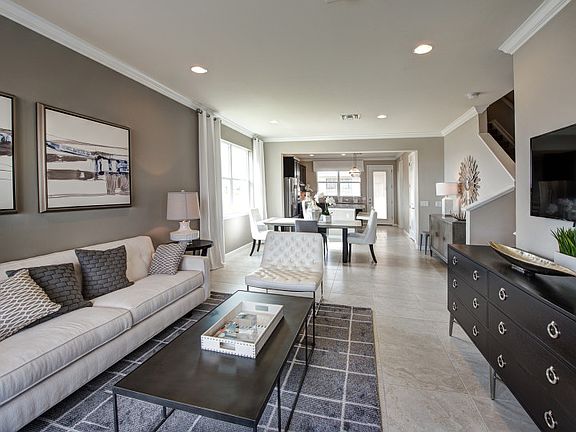 Model Representation Open concept with connected living dining spaces with porcelain tile floors