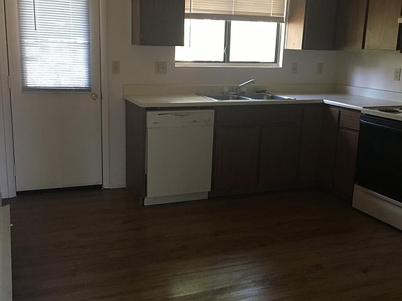 KITCHEN SHOWING BACK DOOR AND DW, SINK, WINDOW