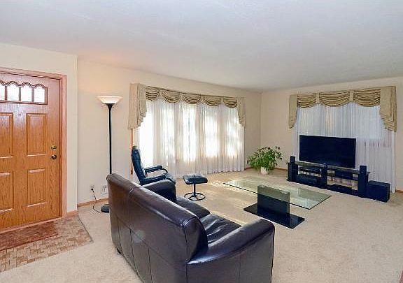 Spacious 21x13 living room with a wood-burning fireplace.