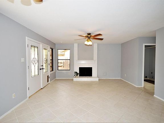 This room can be a family room/dining room or just a dining room complete with a wood burning/gas fireplace. The french doors lead to the private, fully fenced back yard.