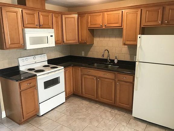 Kitchen with granite countertop & tiled backsplash