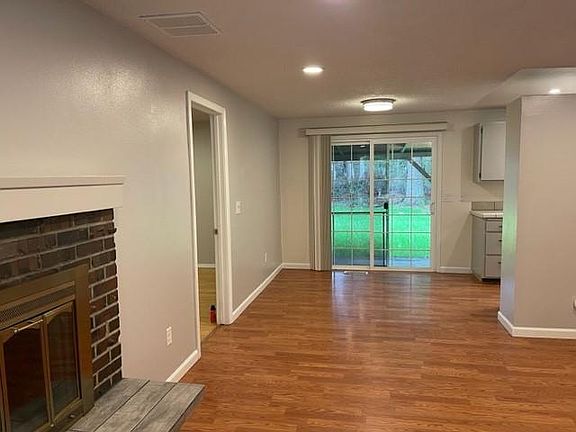Living room into dining room with slider to backyard.