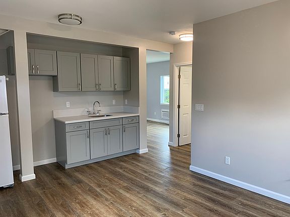 Wet bar featuring all new cabinets, quartz countertops and refrigerator.