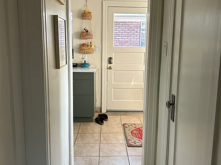 Hallway between office, bedrooms and bathroom (right) that connects to kitchen.