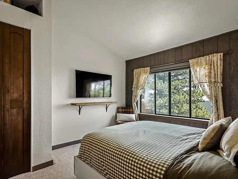 Window has sunrise and city lights views, with custom blackout blinds installed