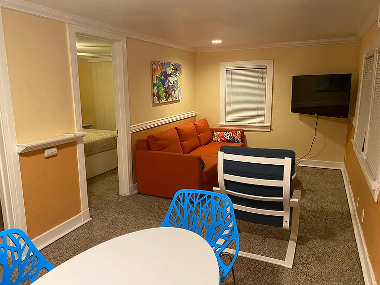 View to furnished living room and bedroom entry