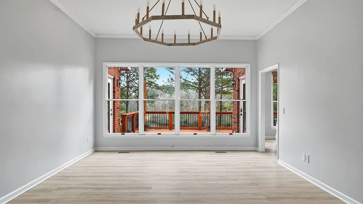 Living area #1 with large windows overlooking the back deck and fenced in back yard. - 130 Woodcrest Rd