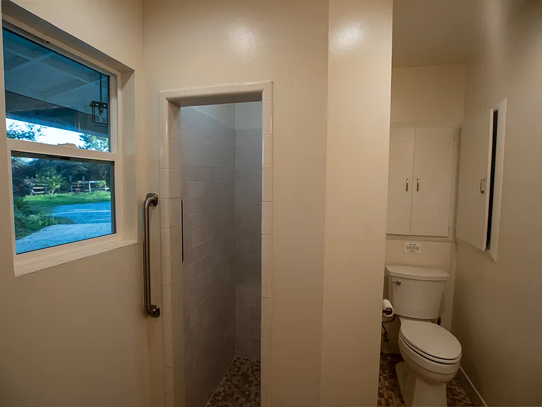 Beautiful views even from the bathroom. Lots of storage in the toilet area with two shelving cabinets.