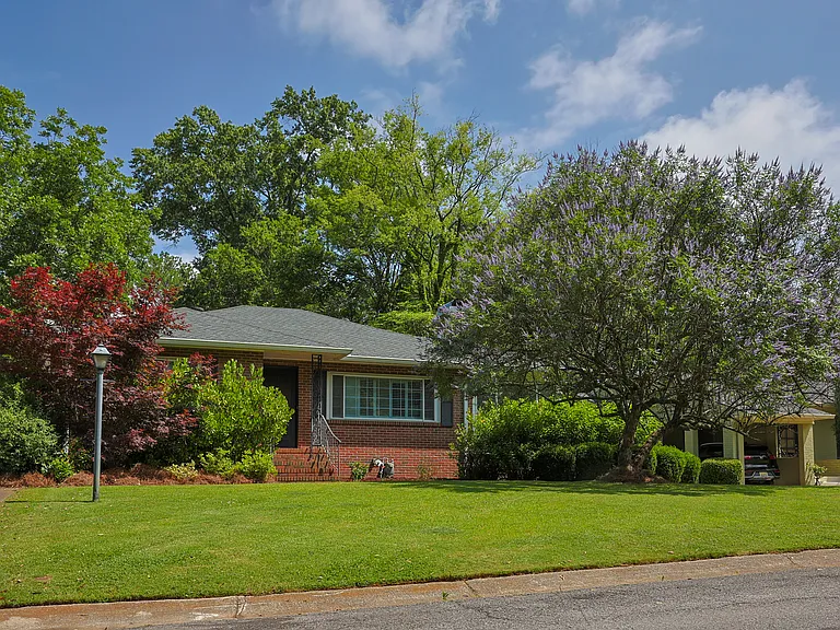 This beautiful brick home has mature landscaping including Japanese maples, a flowering dogwood, and a stunning chaste tree that blooms purple in the front yard.