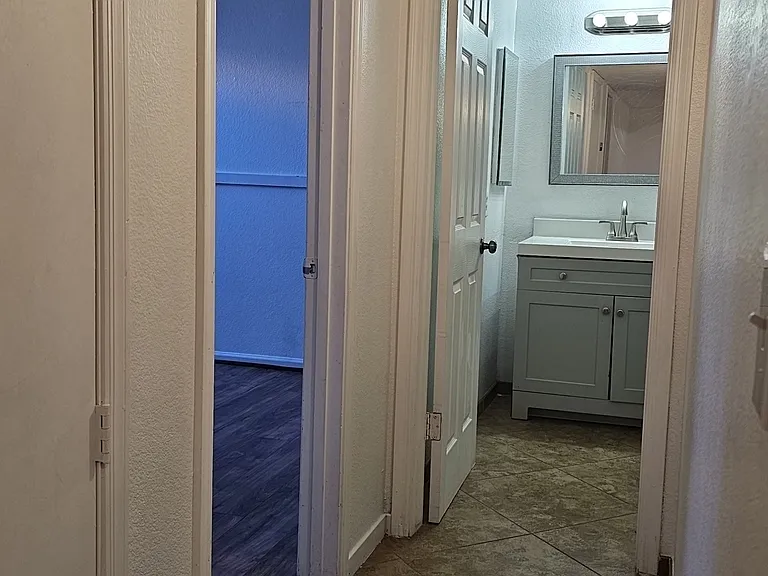 Lower-level hallway providing access to bedrooms and a full bathroom, offering a functional and private layout.